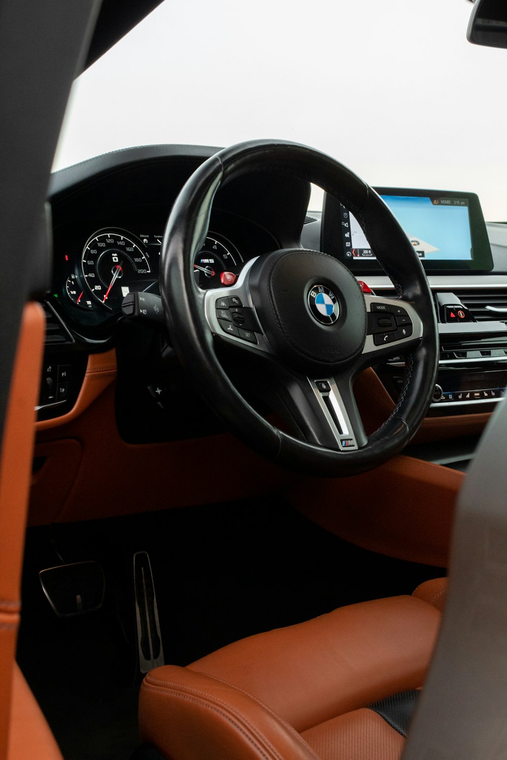 the interior of a car with a steering wheel and dashboard