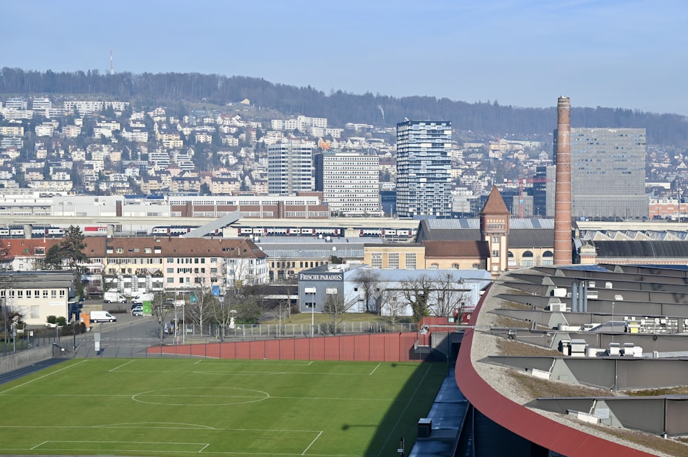 a soccer field in front of a city