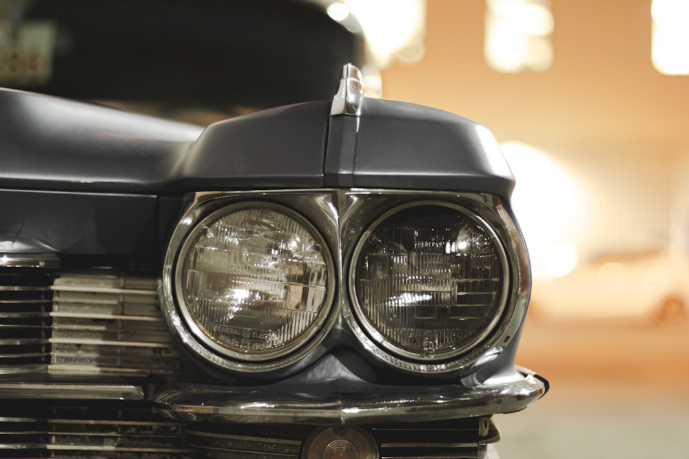 a close up of a car's headlight with a blurry background