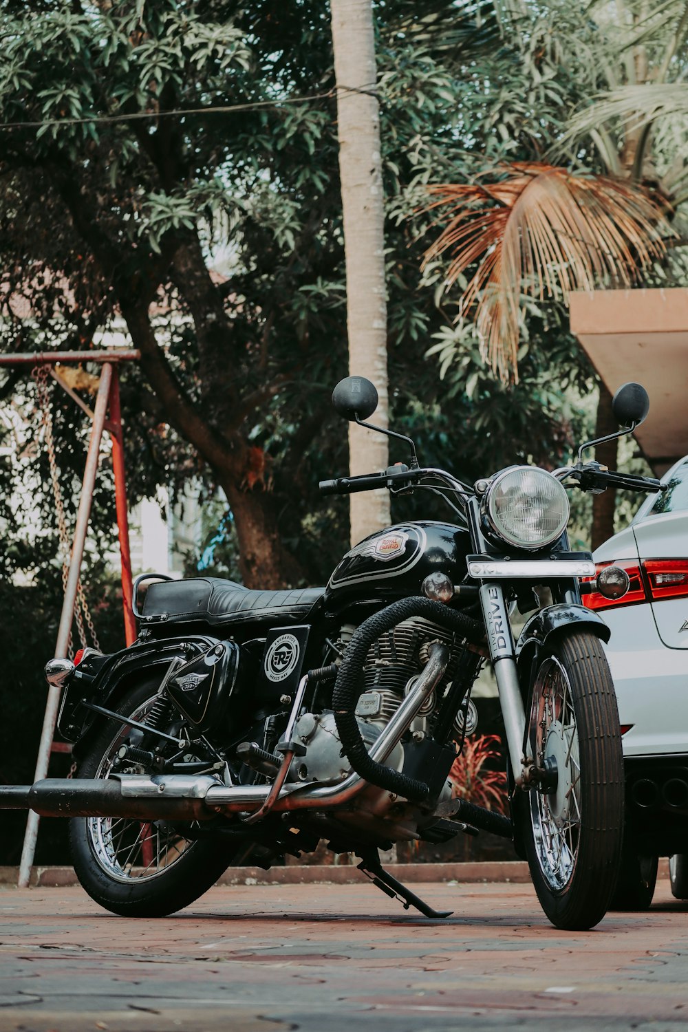 a motorcycle parked next to a white car