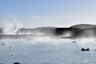A serene sunrise over Yellowstone's iconic geyser basin with steam rising gently.