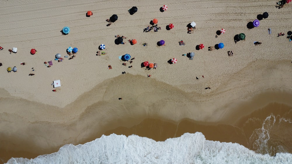 a group of people laying on top of a sandy beach