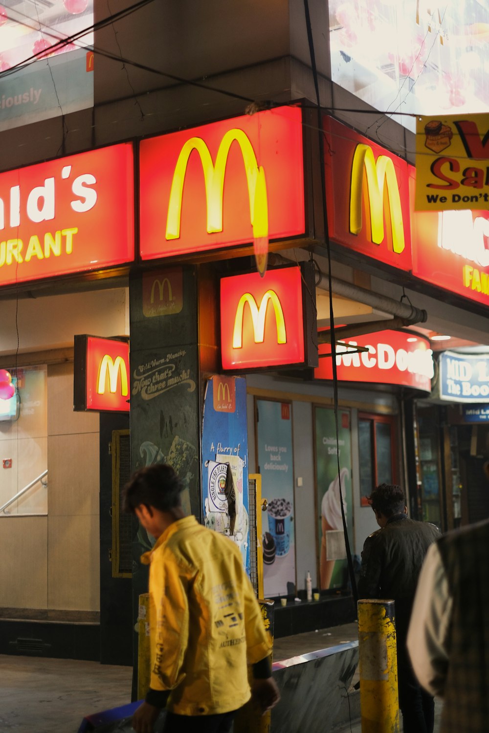 a mcdonald's restaurant with a man walking past it