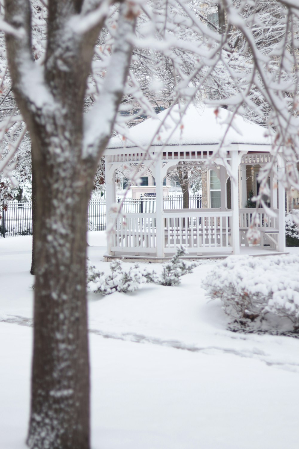 a gazebo in the middle of a snowy yard