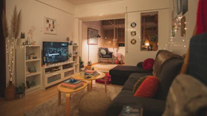 a living room filled with furniture and a flat screen tv