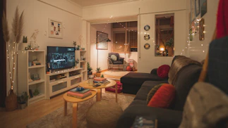 a living room filled with furniture and a flat screen tv