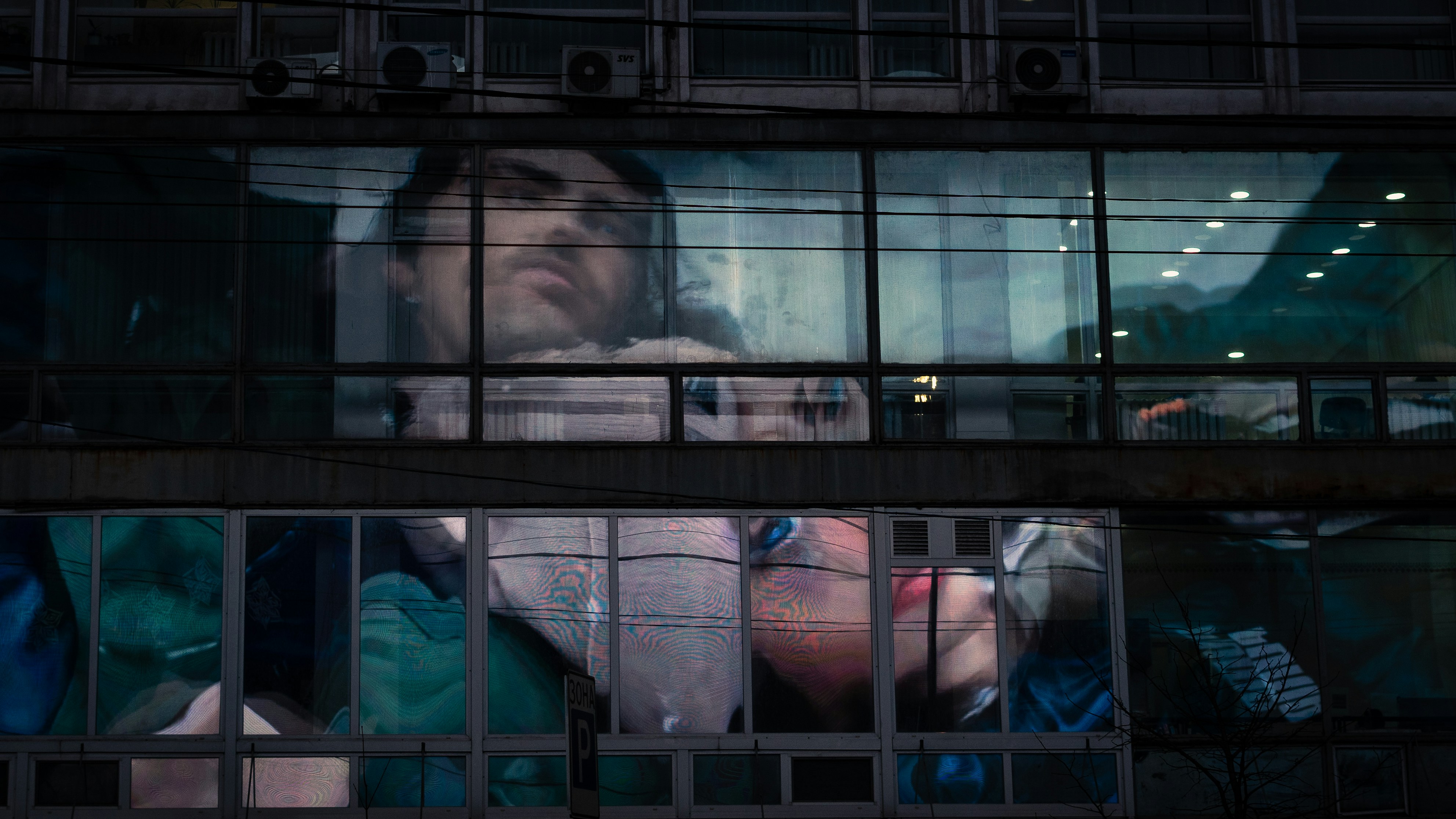 a man is looking out of a window in a building