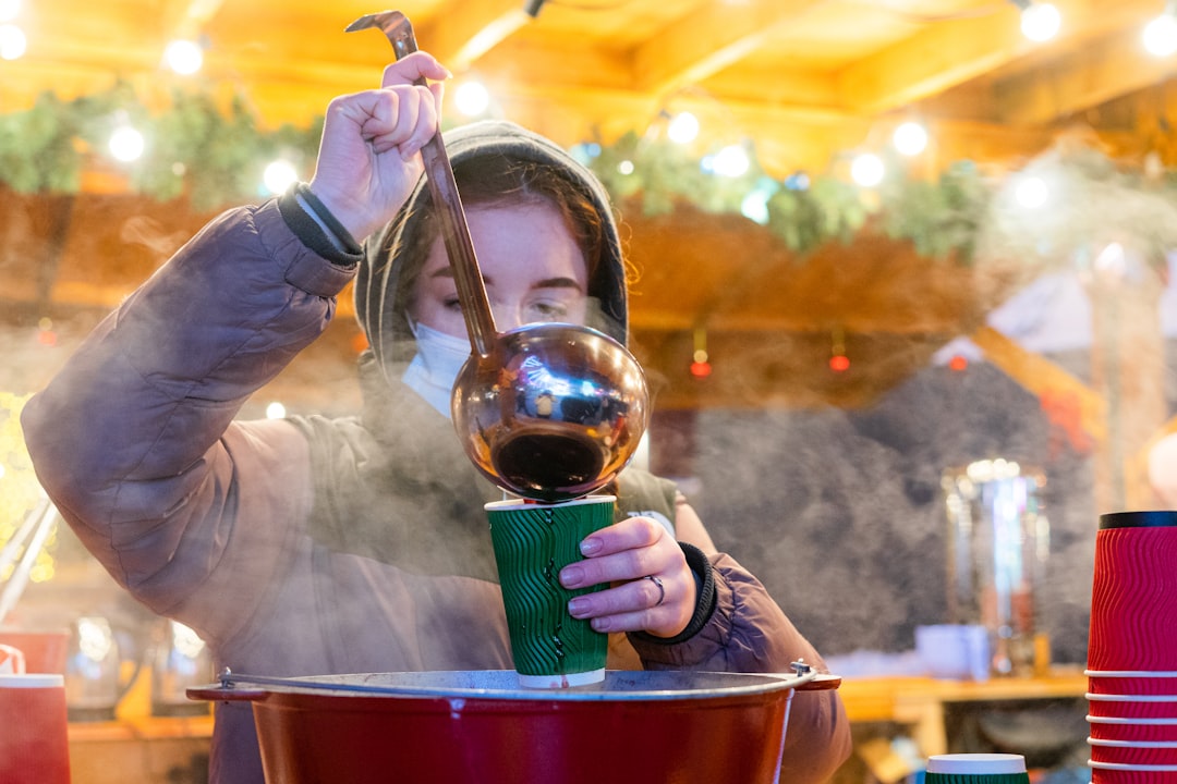 a woman is pouring a cup of coffee,