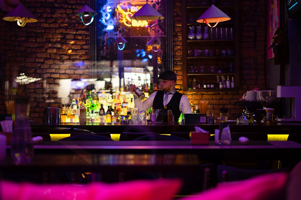 a man sitting at a bar in front of a mirror