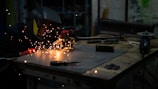 a man in a welding mask working on a piece of metal