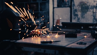 a person using a grinder on a piece of metal