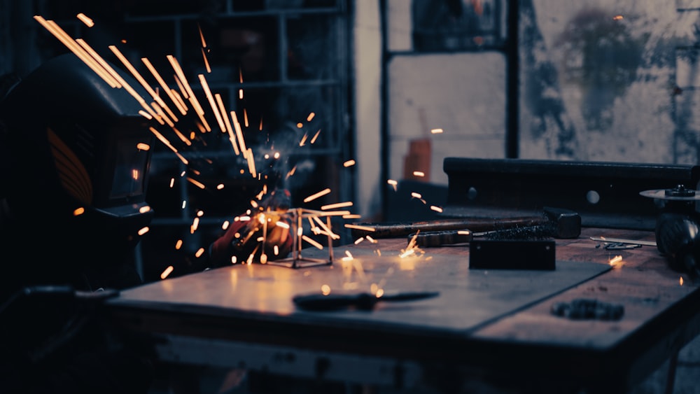 a person using a grinder on a piece of metal