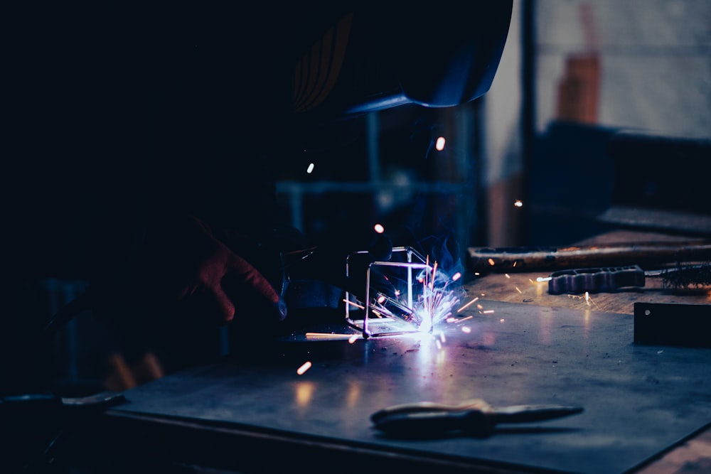 a person working on a piece of metal