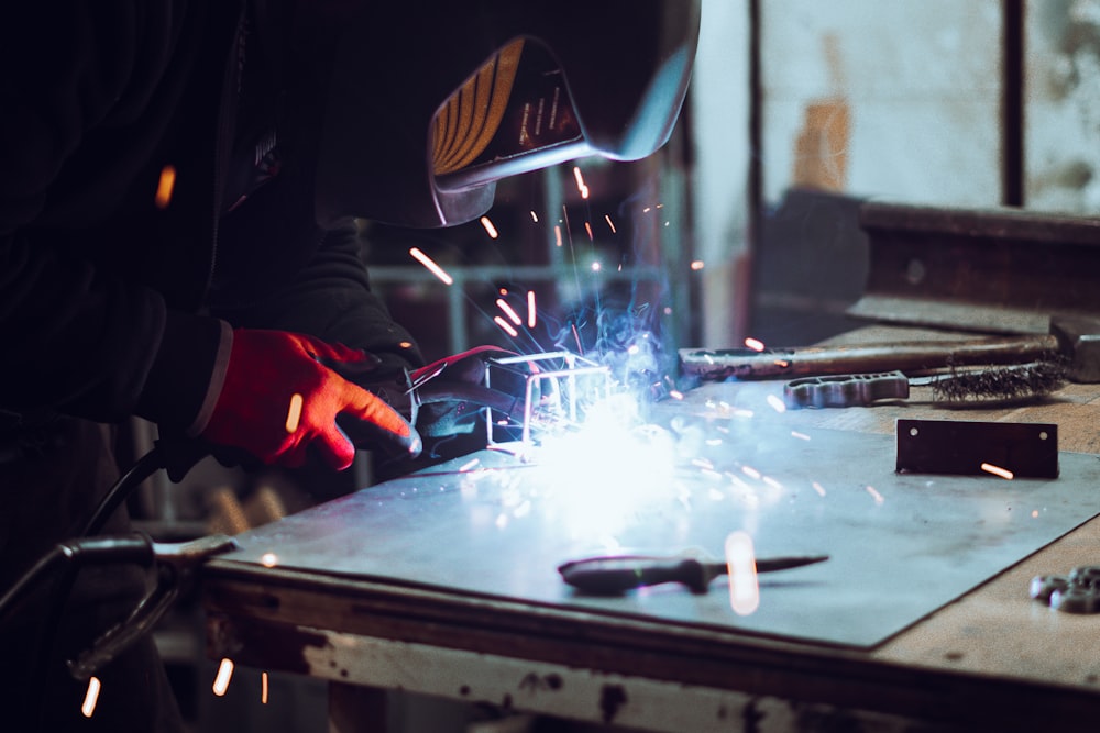 welder working on a piece of metal in a factory