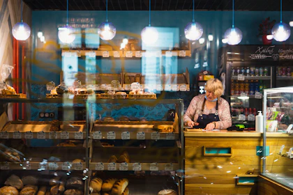 A small business owner behind a bakery counter