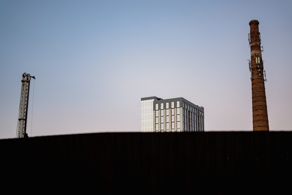 a tall building sitting next to a tall tower