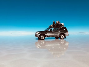 a truck with four people sitting on top of it
