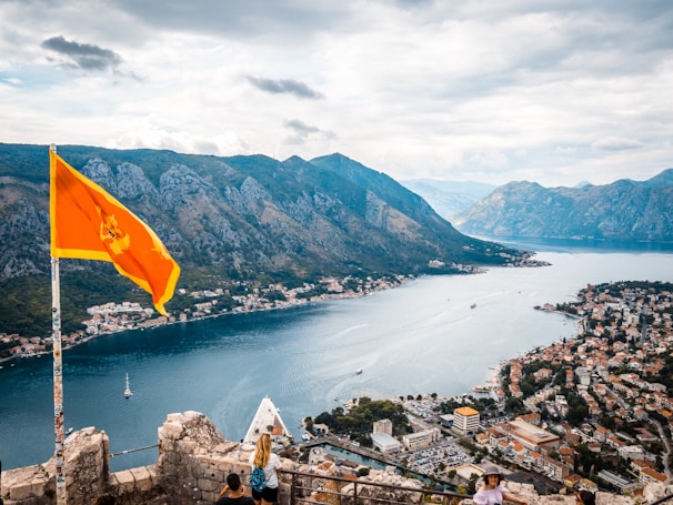 a view of a lake and mountains from a castle