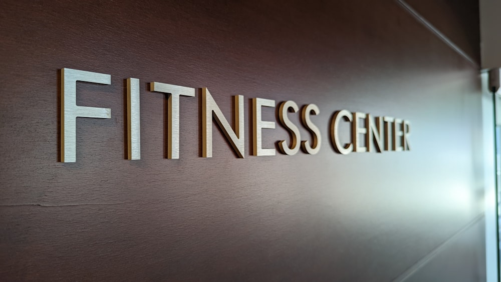 a sign that says fitness center on a wall