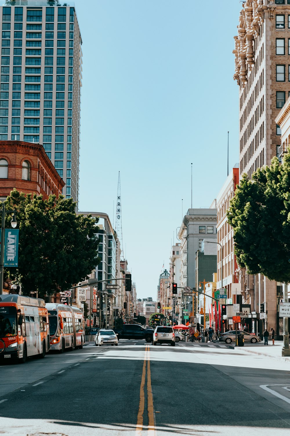 a city street filled with traffic next to tall buildings