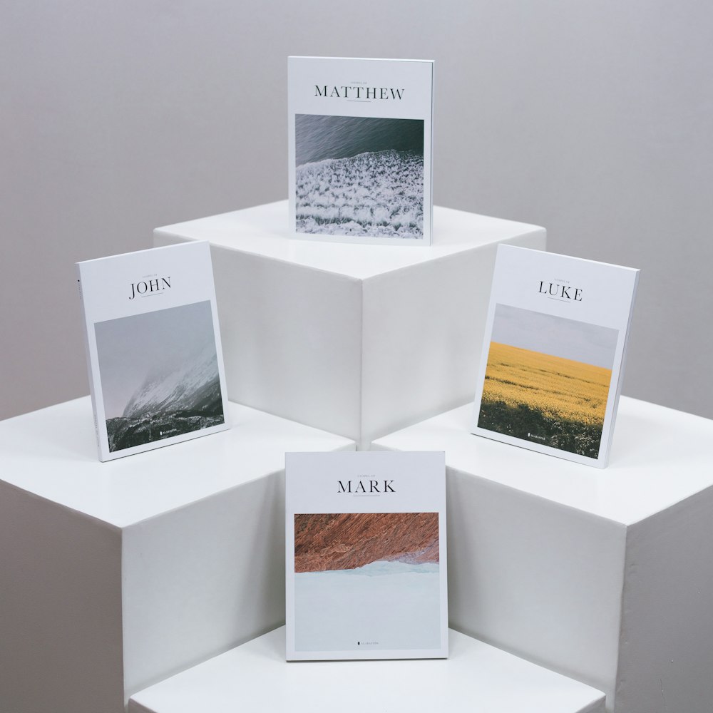 a group of three white boxes sitting on top of a white shelf