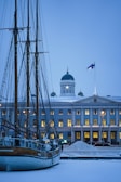 a boat is docked in front of a large building