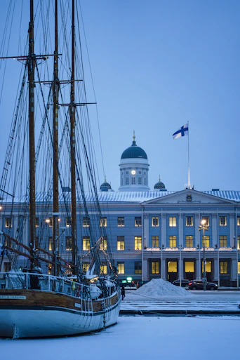a boat is docked in front of a large building