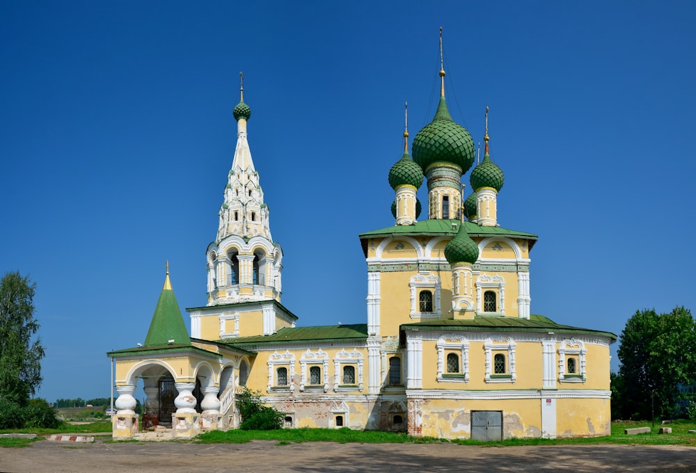 a large yellow and white building with two towers