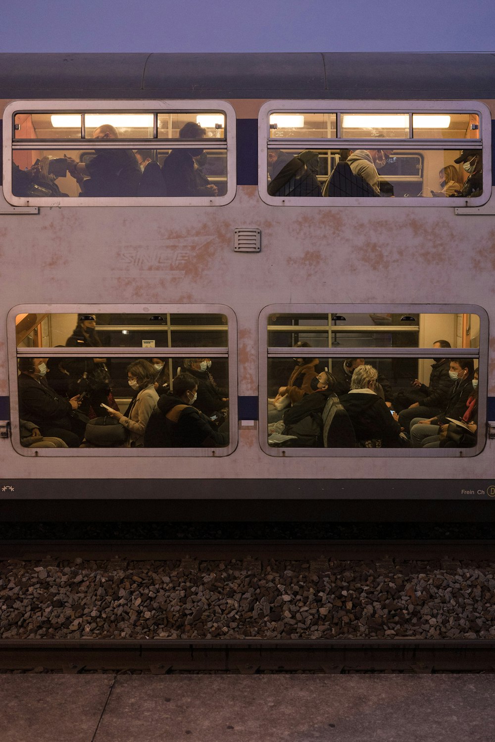 a group of people sitting inside of a train