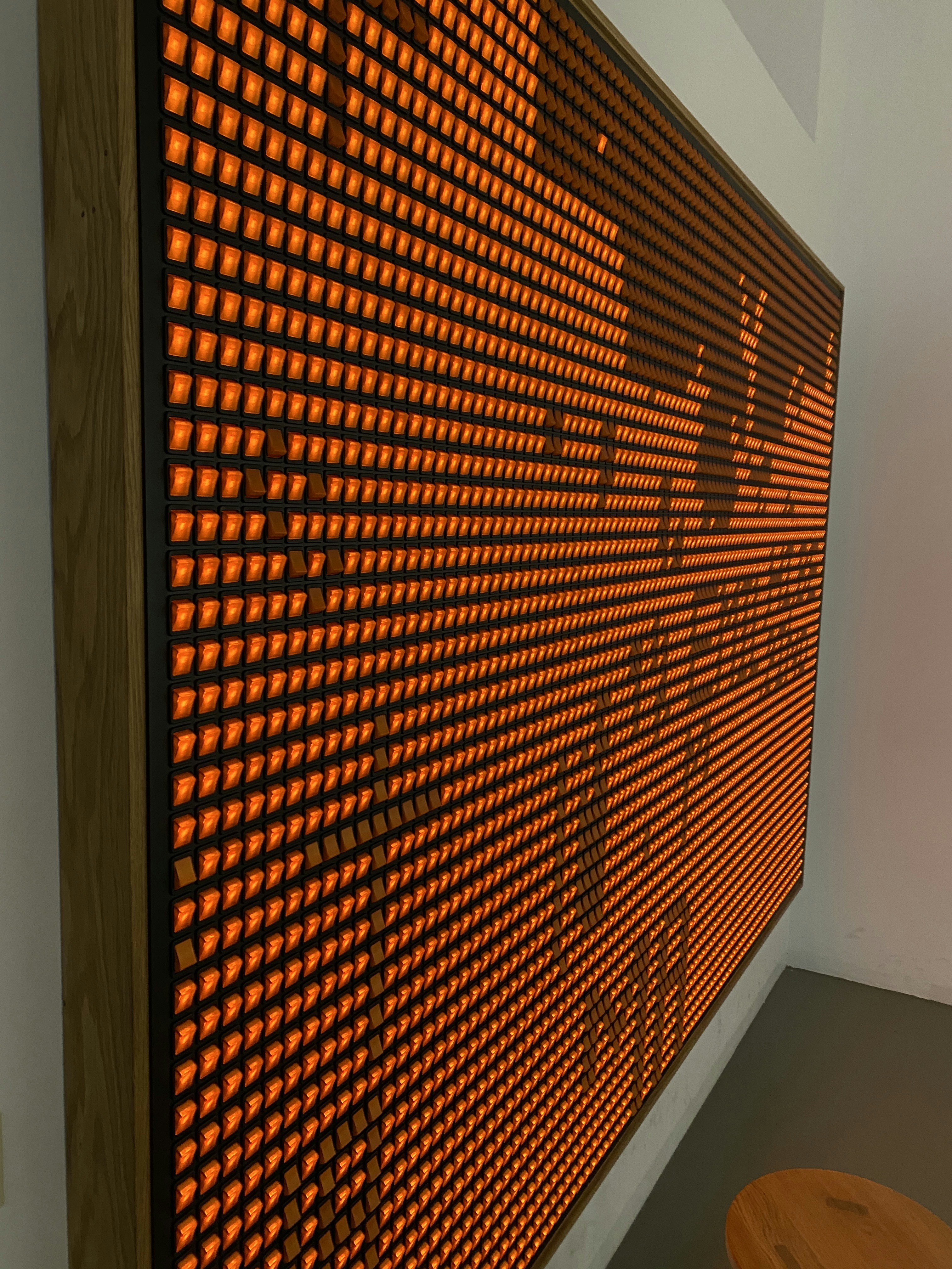 a wall with a large orange display screen