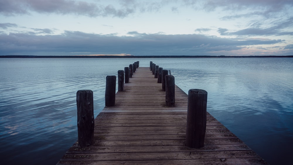 a wooden dock in the middle of a body of water