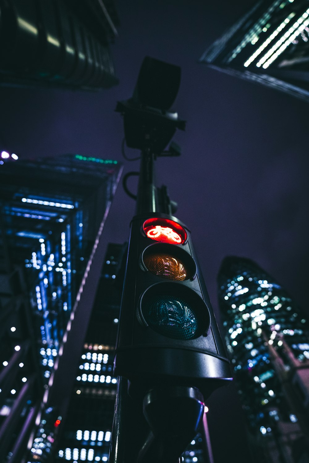 a traffic light in the middle of a city at night