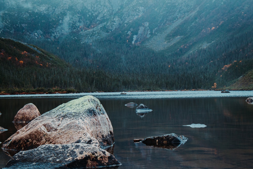 a large rock in the middle of a body of water