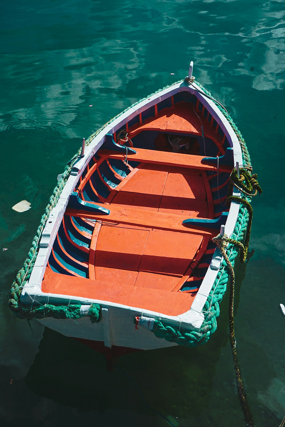 an orange and white boat in the water