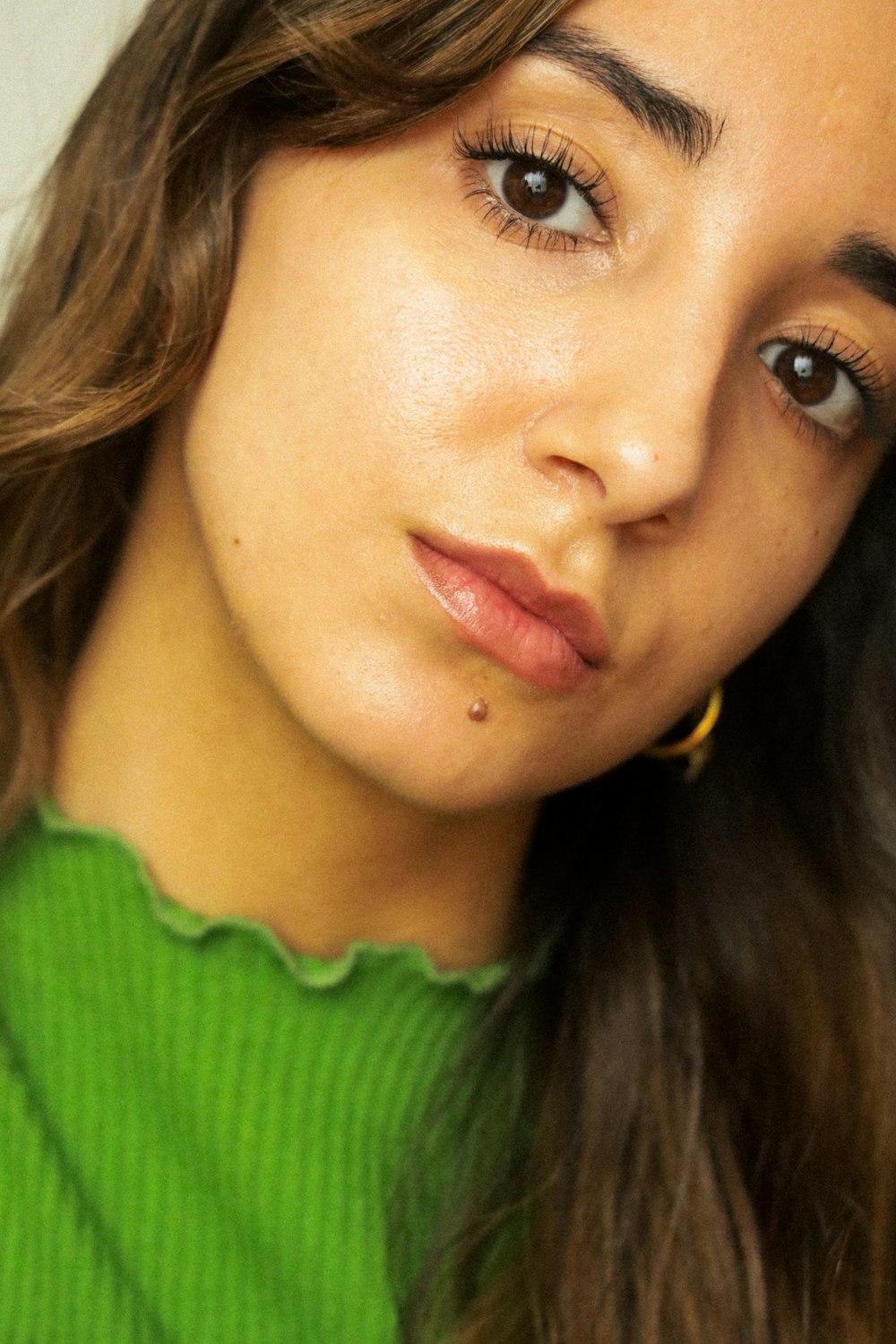 a close up of a person wearing a green shirt