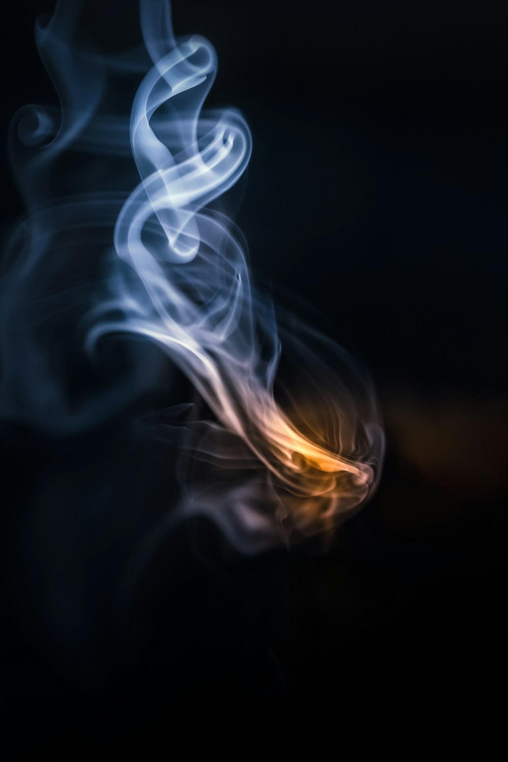 a blurry photo of smoke on a black background