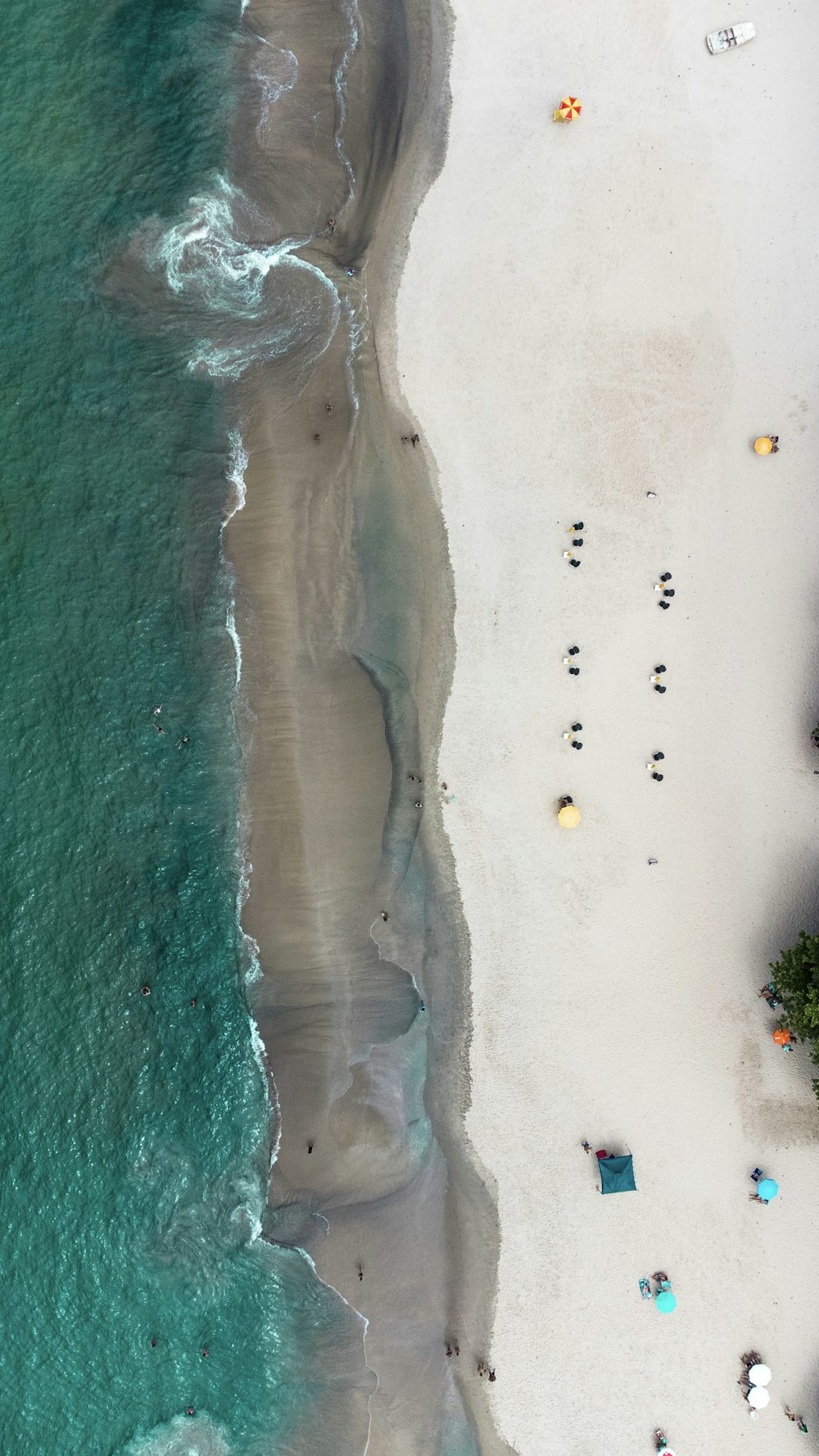 an aerial view of a sandy beach and ocean