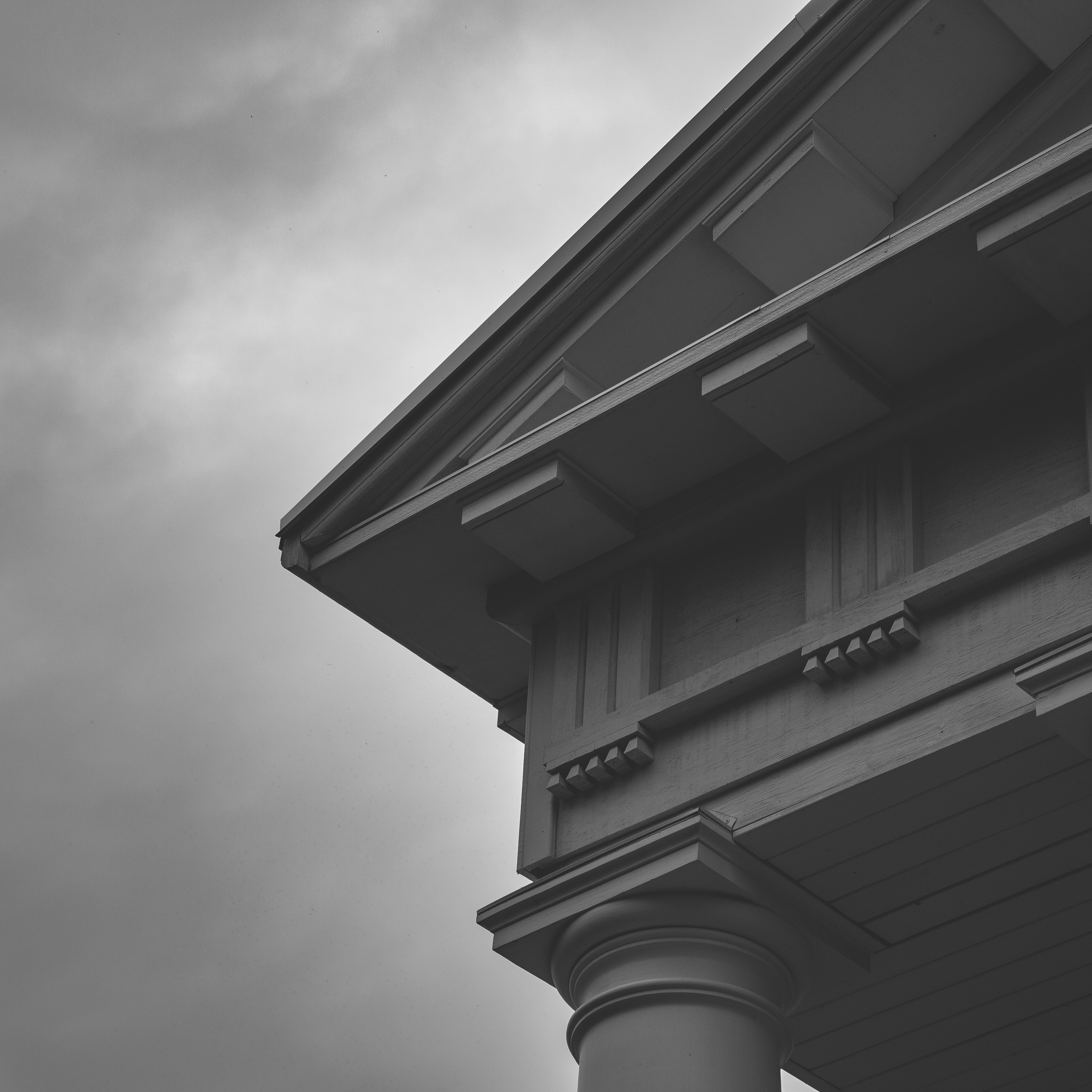 a black and white photo of a building with a clock