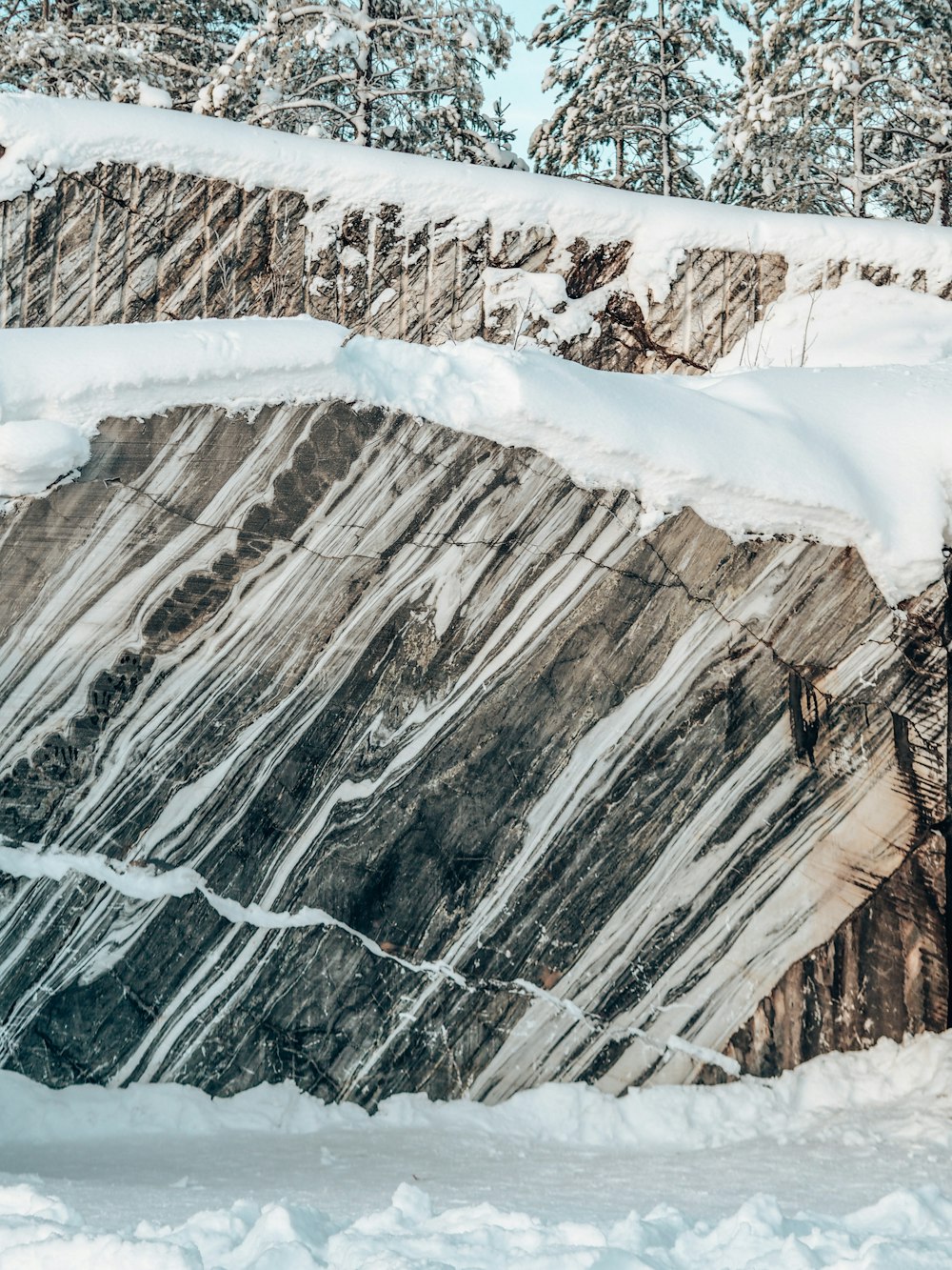 a man riding a snowboard down a snow covered slope