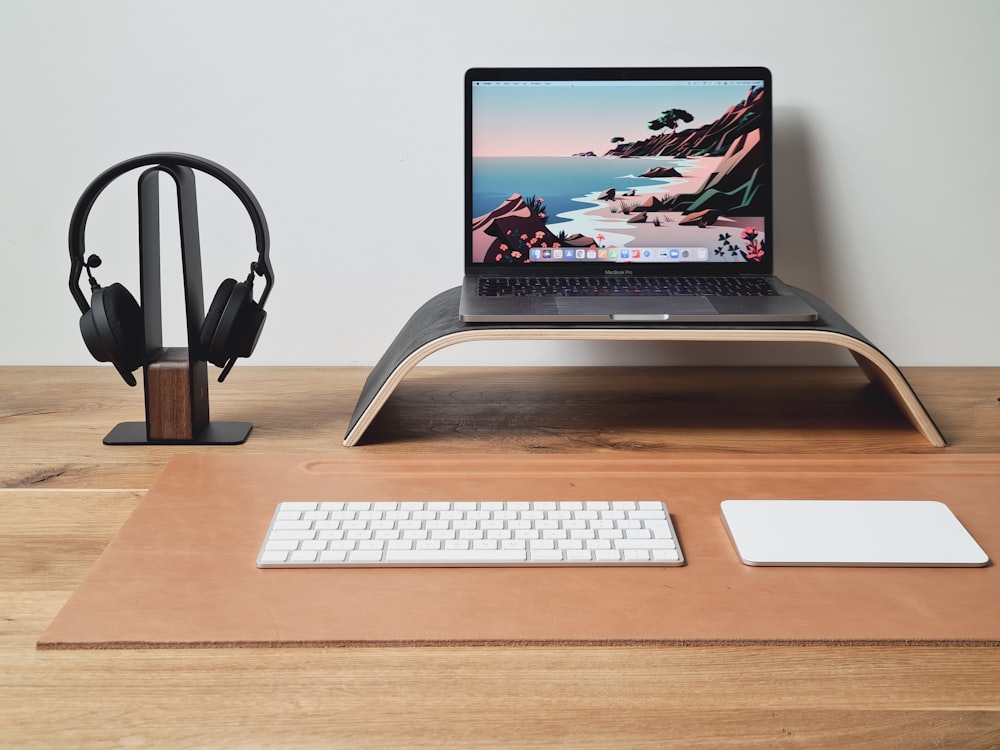 a laptop computer sitting on top of a wooden desk