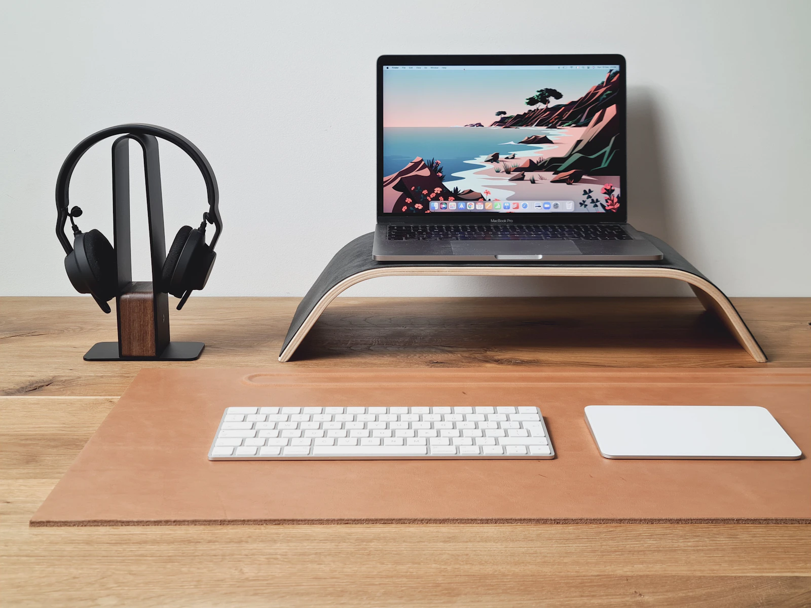 Laptop elevated on a stand in a clean workspace