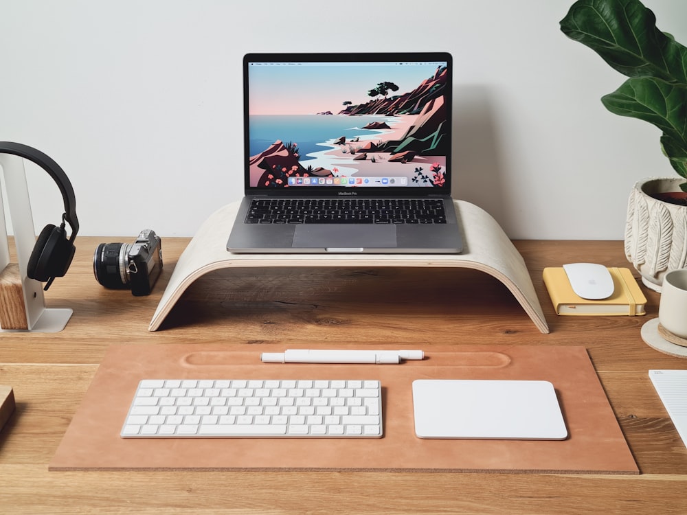 a laptop computer sitting on top of a wooden desk