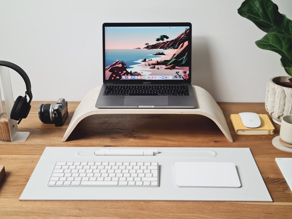 a laptop computer sitting on top of a wooden desk