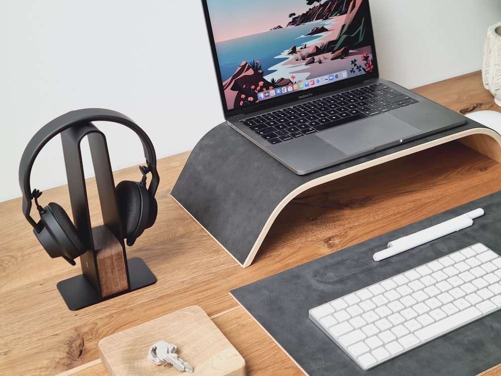 a laptop computer sitting on top of a wooden desk