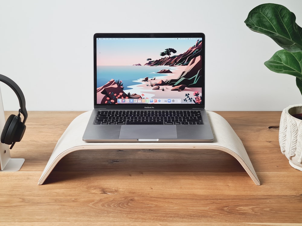 a laptop computer sitting on top of a wooden desk