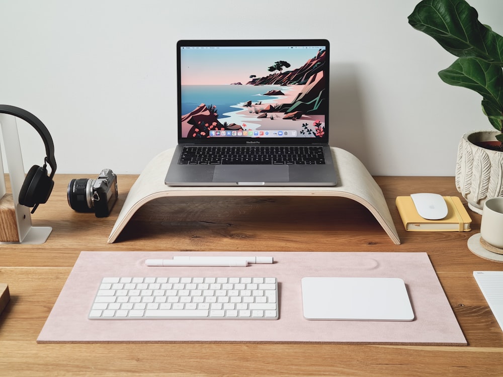 a laptop computer sitting on top of a wooden desk