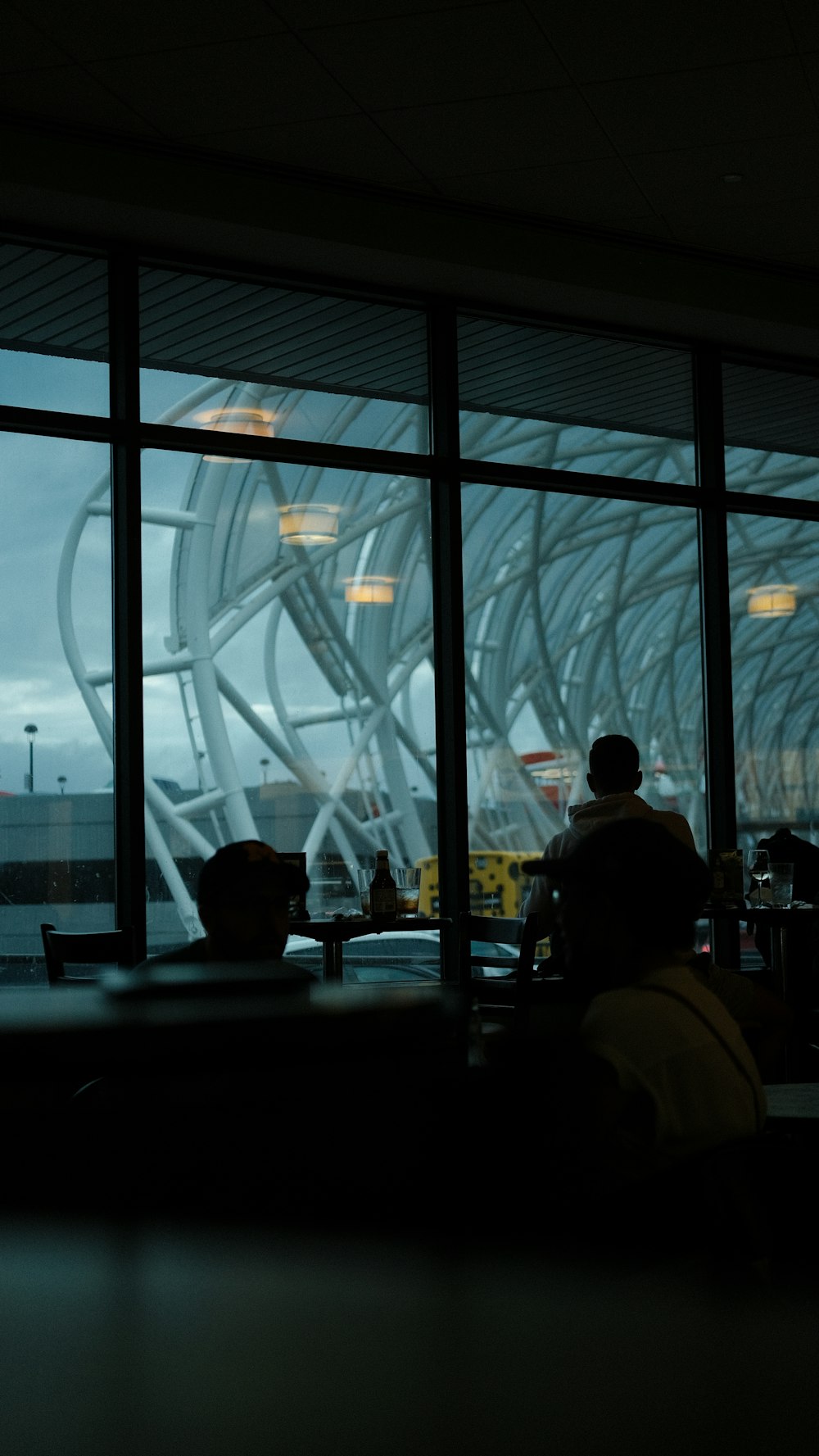 a man sitting at a table in front of a window