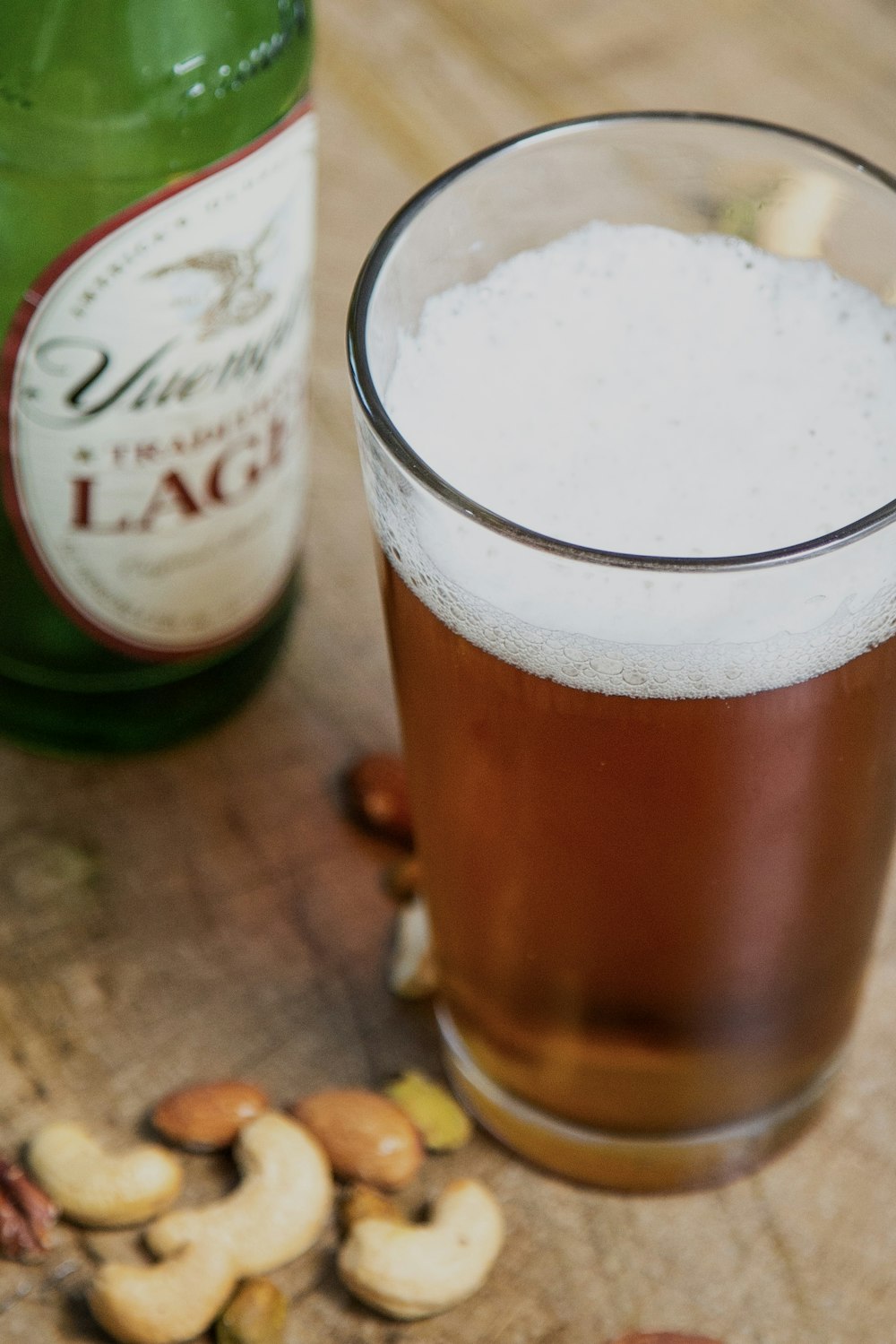 a close up of a glass of beer on a table