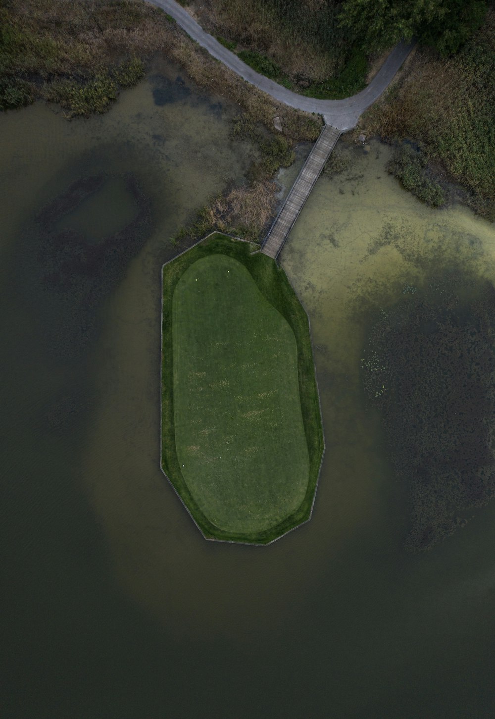 an aerial view of a golf course in the water