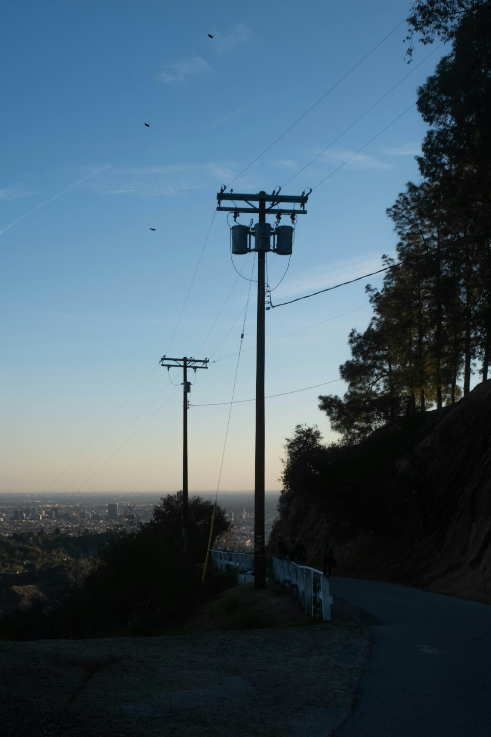 a telephone pole on the side of a road